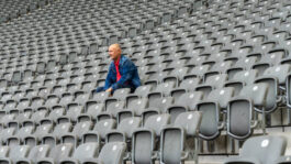 Low Angle View Of Man Sitting In Stadium