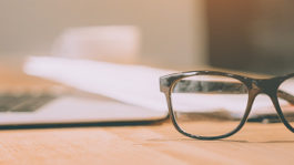 The modern laptop and glasses on the table