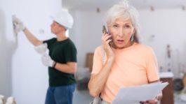 iStock-1419708861-home-improvement-scams-woman-on-the-phone-with-contrctor-in-background-650×433-1.jpeg