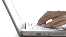 Close up of a hand typing on the laptop