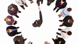 Businessmen Meeting Amongst a Circle of Businesspeople – Isolated