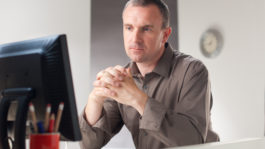 Thinking businessman at office desk