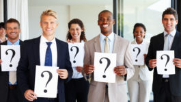 Business team holding question mark signs