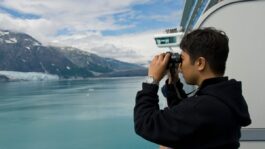 Person_using_binoculars_on_cruise_ship_GdSIfWH.jpeg