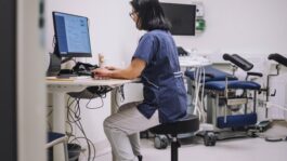 doctor_using_computer_in_exam_room.jpeg