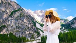 woman-taking-picture-scenic-mountain-setting.jpeg