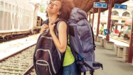 backpacker-wearing-two-rucksacks-train-platform.jpeg