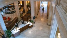 0fadae-20260508-people-walk-through-a-boutique-hotel-lobby-2000.jpg