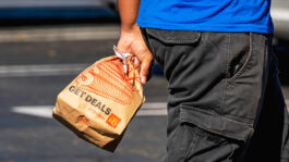 A customer carries a McDonald's bag outside a restaurant in El Sobrante, California, USA