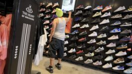 Retailers like Foot Locker see downturn in sneaker sales 877335-20260826-a-man-shops-for-sneakers-2000
