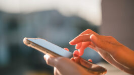 Hand holding smart phone in Social media marketing concept. hand using smartphone typing, chatting conversation in chat box icons pop up