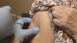 Close-up of senior woman receiving dose of Covid-19 vaccine